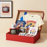 Retro-themed WhatUTalkingBoutWillis gift box featuring a mug, T-shirt, wall art, collectibles, stickers, and a personalized card.
